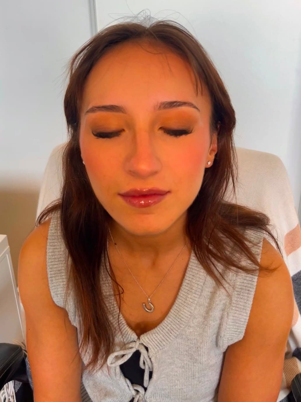 Client glam look eyes closed — glossy lip and soft lashes by Ottawa MUA Zara