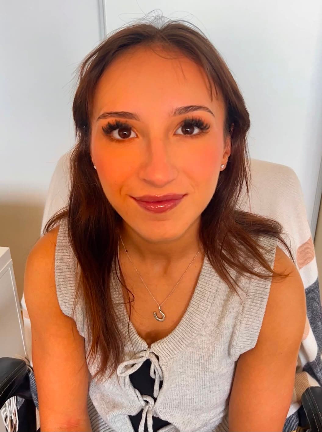 Client glam look eyes open — full lashes and warm berry tones by Zara Does Makeup